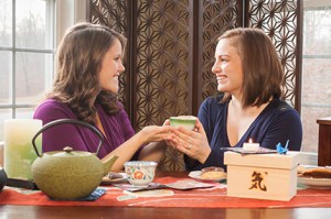 A woman shares a just because gift of Ki in a Box® with her friend.